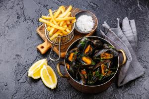 a bowl of mussels and french fries with a bowl of rice and a plate at Campanile Conflans-Sainte-Honorine in Conflans-Sainte-Honorine +32 photos