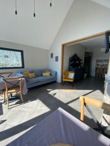 a living room with a couch and a table at Chez Mary Elise in Le Claux