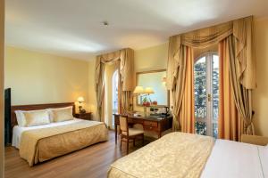 Un pat sau paturi într-o cameră la Hotel Verdeborgo