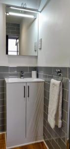 a bathroom with a white sink and a mirror at Hartfell Guest House in Moffat