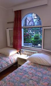 a bedroom with two beds and a window at Apartment City Garden in Kotor