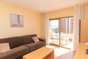 a living room with a couch and a table at Aparto Residence Galetamar in Calpe