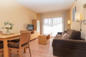 a living room with a couch and a table in a room at Aparto Residence Galetamar in Calpe