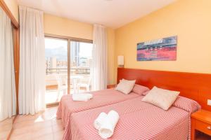 a bedroom with a bed with white towels on it at Aparto Residence Galetamar in Calpe