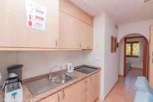 a kitchen with a sink and a counter top at Aparto Residence Galetamar in Calpe