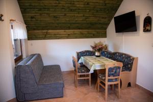 a dining room with a table and chairs at Vineyard Cottage Brodaric in Metlika