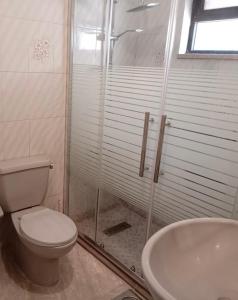 a bathroom with a shower and a toilet and a sink at Abdoun ground floor apartment in Amman +16 photos
