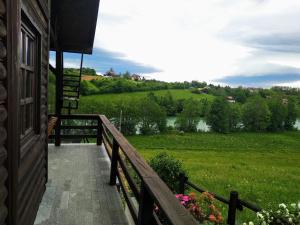 a porch of a house with a view of a field at House for rent Mrežnica in Duga Resa