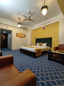 a large bedroom with a bed and a couch at Grand Mostafa Hotel Ababil in Sylhet