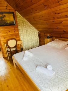 a bedroom with a bed with towels on it at House for rent Mrežnica in Duga Resa