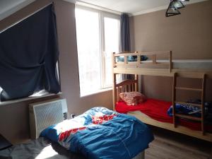 a bedroom with two bunk beds and a window at BLUE Hostel in Tbilisi City