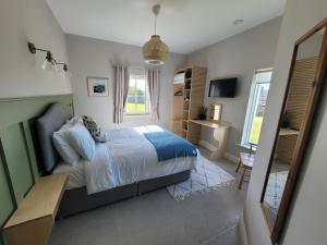 a bedroom with a bed and a window at Aiteall Boutique Accommodation in Liscannor