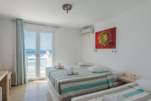 a bedroom with two beds and a view of the ocean at Paradise Beach Resort in Paradise Beach