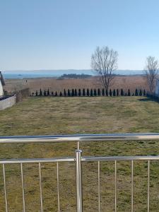 a fence in front of a field with trees at Pokoje u Teresy Rewa in Rewa +25 photos