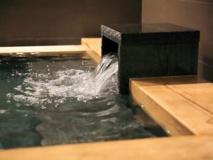 a water fountain in a pool of water at Solaria Nishitetsu Hotel Kyoto Premier in Kyoto
