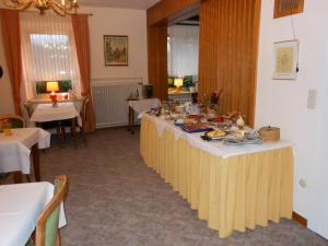 a table with food on it in a room at Westfalenhof Garni in Willingen