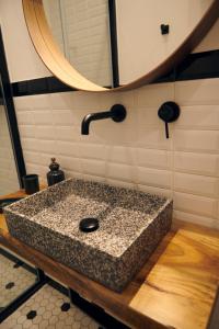 a bathroom with a granite sink and a mirror at DADA home, Loft di 38 Mq tra Napoli e Pompei in Portici