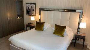 Un ou plusieurs lits dans un hébergement de l'établissement Hôtel Le Canberra
