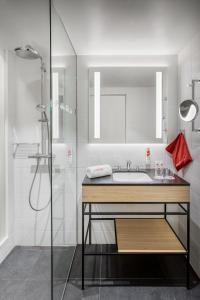 a bathroom with a sink and a shower at IntercityHotel Amsterdam Airport in Hoofddorp