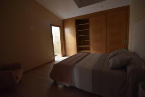 Łóżko lub łóżka w pokoju w obiekcie Casa A Pedra