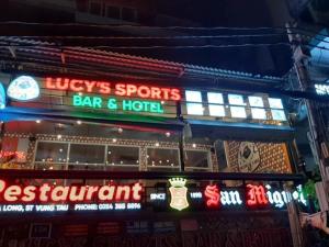 a bar and hotel with neon signs in front of it at Lucys Hotel in Vung Tau