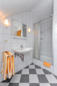 a bathroom with a sink and a shower at Ferienwohnung im Haus Solea in Esens +10 photos