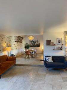 a living room with a couch and a table at La Ferme de Fontenelle in Amillis