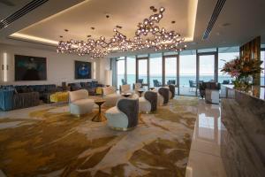 a large lobby with chairs and a chandelier at Limassol Del Mar in Limassol
