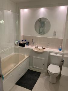 a bathroom with a sink and a tub and a toilet at NEW Superb One Bedroom Getaway in Dysart Kirkcaldy in Kirkcaldy
