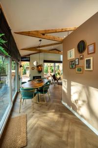 a dining room with a table and chairs at ZEN-Bungalow NO 3 met sauna en hottub in Rheezerveen