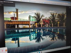 a computer screen with a picture of a swimming pool at Il Mondo Di Sofia in Canoa Quebrada