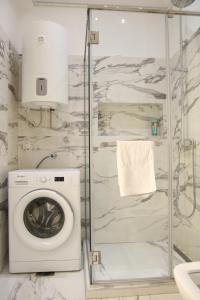 a bathroom with a washing machine and a shower at Natalie's Royal M in Belgrade