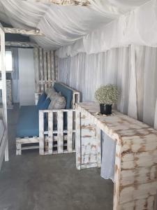a room with a tent with a table and a couch at Complexo Baleia Azul Camping in Ponta do Ouro