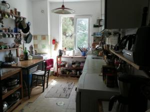 a kitchen with a counter and a window at Ecer Pansiyon in Kuşadası