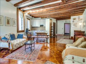 a living room with couches and a table at La Terrazza di San Marco - Luxury Apartment in Venice
