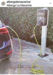 a car is hooked up to a electric car charger at Le Macerine in Castiglione del Lago