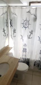 a bathroom with a lighthouse shower curtain with a toilet at Providencia Cercano a Clínicas y Hospitales in Santiago
