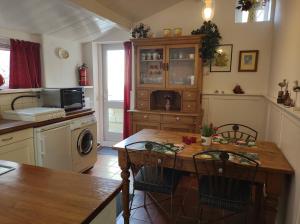 a kitchen with a table and a stove and a microwave at STRANDGAPER Bed by the Sea in Westkapelle