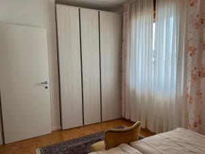 a bedroom with a closet and a bed and a door at Haus Romagnoli Residence in Lazise