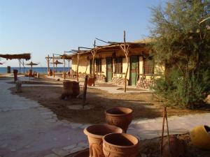 a building with some pots in front of it at Sayadeen Village - Red Sea Riviera in Nuweiba