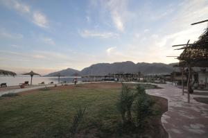 a view of a beach with mountains in the background at Sayadeen Village - Red Sea Riviera in Nuweiba