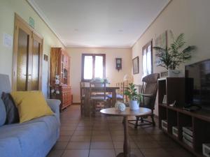 a living room with a couch and a table at LOPENEA in Garzáin