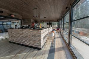 a kitchen with a brick counter and windows at Hotel Cumpatu in Sinaia