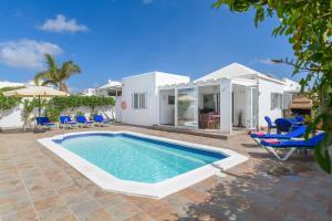 a swimming pool in front of a villa at Villa Hermosa in Puerto del Carmen