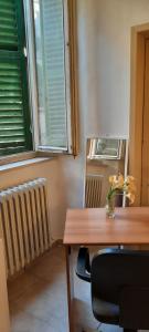 a dining room table with a vase of flowers on it at Alessi B&B in Perugia