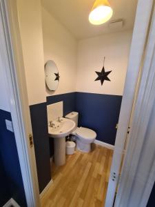 a bathroom with a toilet and a sink at Delightful 3 bed house nr the centre of Cheltenham in Cheltenham