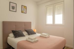 a bedroom with a bed with two towels on it at Modern Penthouse with Private Terrace in Valencia