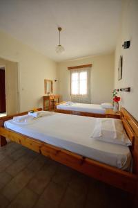 two large beds in a room with a window at Studios Calvinos in Marathokampos