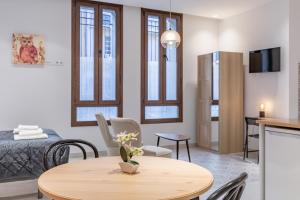 a living room with a table and a bedroom at Gorgeous Apartment close to City Centre in Valencia