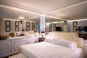 a large bedroom with two beds and a mirror at Excelsior Palace Portofino Coast in Rapallo